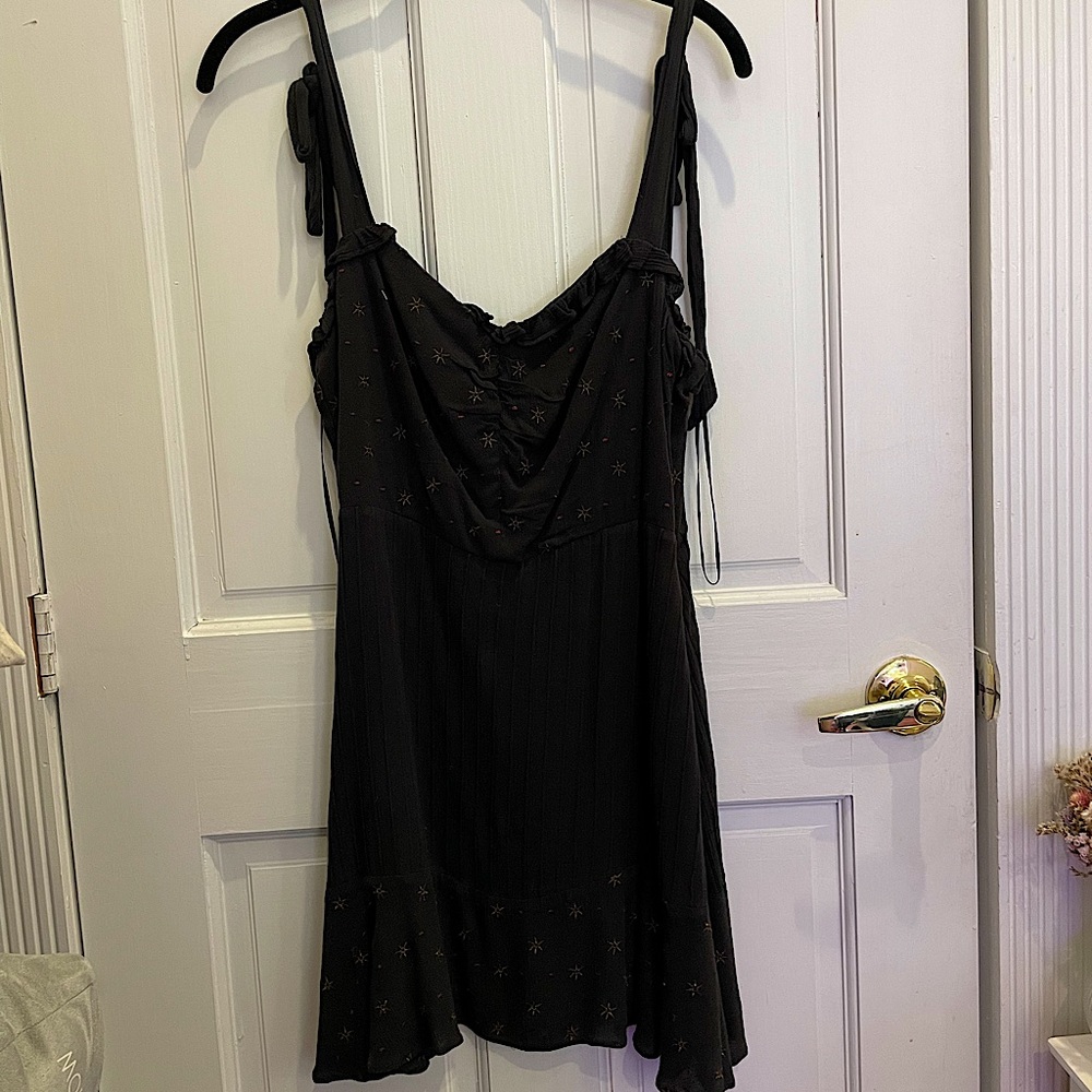 Black sundress with star detailing and tie straps